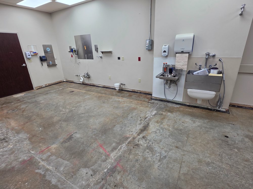 Before photo of commercial concrete floor before medical cleanroom coating