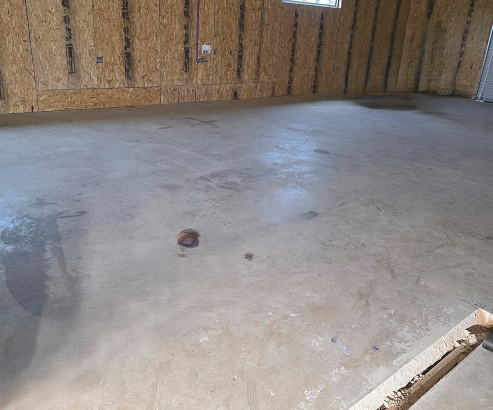 Before photo of worn shop concrete before coating
